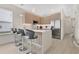 Modern kitchen featuring an island with bar seating and stainless steel appliances at 17519 Hidden Forest Dr, Clermont, FL 34714