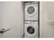A clean laundry closet showcasing a stacked Samsung washer and dryer unit at 17519 Hidden Forest Dr, Clermont, FL 34714