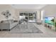 Bright living area featuring stylish furniture and sliding glass doors to the screened patio at 17519 Hidden Forest Dr, Clermont, FL 34714