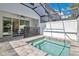 Inviting screened-in pool area with a -safety fence, patio seating, and access to the home at 17519 Hidden Forest Dr, Clermont, FL 34714