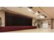 The stage has a large curtain with a neutral color scheme, ample lighting, and is surrounded by neutral-colored walls at 3715 Westerham Dr, Clermont, FL 34711