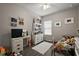Cozy bedroom with a white dresser, decor and window with natural light at 456 Winter Solstice Ln, Mount Dora, FL 32757