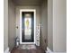 Inviting front door with decorative glass, a welcome mat, and a charming welcome sign at 456 Winter Solstice Ln, Mount Dora, FL 32757