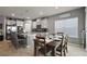 Open kitchen and dining area with a granite island, modern appliances, and a farmhouse design at 456 Winter Solstice Ln, Mount Dora, FL 32757
