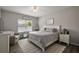 Serene main bedroom with a large window and calm decor at 456 Winter Solstice Ln, Mount Dora, FL 32757