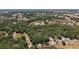 A broad overhead shot of land showing a tranquil pond surrounded by verdant forestry at 5787 Marion County Rd, Lady Lake, FL 32159