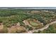 An aerial view of a property featuring a tranquil pond and lush greenery at 5787 Marion County Rd, Lady Lake, FL 32159