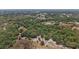 Overhead view displays a sprawling property with a picturesque pond and diverse trees at 5787 Marion County Rd, Lady Lake, FL 32159