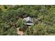 Secluded home nestled within lush, mature trees providing privacy and shade at 5787 Marion County Rd, Lady Lake, FL 32159