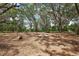 Rustic fire pit area surrounded by mature trees and foliage at 5787 Marion County Rd, Lady Lake, FL 32159