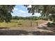 Scenic rural property featuring a pond and open fields with lush trees at 5787 Marion County Rd, Lady Lake, FL 32159