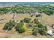 Expansive aerial view showcasing the property's generous acreage, mature trees, and private pond at 602 Cr 489, Lake Panasoffkee, FL 33538