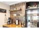 Beautiful bar area with a wine fridge, open shelving, and decorative glassware at 602 Cr 489, Lake Panasoffkee, FL 33538