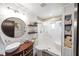 Bathroom features modern fixtures, a white vessel sink, decorative shelving, and glass shower with bench seat at 602 Cr 489, Lake Panasoffkee, FL 33538