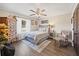 Cozy bedroom with a ceiling fan, hardwood floors, and a decorative chest at 602 Cr 489, Lake Panasoffkee, FL 33538