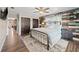 Spacious bedroom featuring wood accents, large windows, and a comfortable bed at 602 Cr 489, Lake Panasoffkee, FL 33538