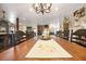 Dining room features an ornate chandelier and wooden dining table with seating for ten guests at 602 Cr 489, Lake Panasoffkee, FL 33538