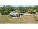 Expansive property featuring a charming home, mature trees, and a detached structure in a serene, rural setting at 602 Cr 489, Lake Panasoffkee, FL 33538