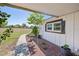 Charming home exterior features a well-kept walkway, decorative shutters, and tidy landscaping at 602 Cr 489, Lake Panasoffkee, FL 33538