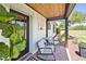 Charming front porch with comfortable seating, decorative plants, and wood accents, perfect for relaxing at 602 Cr 489, Lake Panasoffkee, FL 33538