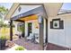 Inviting front porch with brick flooring, rocking chairs, and stylish accents, creating a welcoming entrance at 602 Cr 489, Lake Panasoffkee, FL 33538