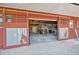 Large garage with open sliding barn doors, offering ample space for projects and storage at 602 Cr 489, Lake Panasoffkee, FL 33538