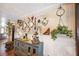 Vintage hallway decor with decorative plates, wall hangings, and rustic-style furniture at 602 Cr 489, Lake Panasoffkee, FL 33538