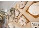 Hallway decor features vintage ceramic dishes in wooden frames and farmhouse style decor at 602 Cr 489, Lake Panasoffkee, FL 33538