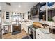 Beautiful kitchen with stainless steel appliances, farmhouse sink, and white subway tile backsplash at 602 Cr 489, Lake Panasoffkee, FL 33538