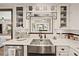 Charming kitchen features a stainless steel farmhouse sink, white marble countertops, and subway tile backsplash at 602 Cr 489, Lake Panasoffkee, FL 33538