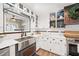 Charming kitchen with white cabinets, subway tile backsplash, and stainless steel farmhouse sink at 602 Cr 489, Lake Panasoffkee, FL 33538
