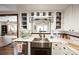 Bright kitchen with white cabinets, stainless steel sink, marble countertop, and open design concept at 602 Cr 489, Lake Panasoffkee, FL 33538