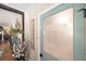 Farmhouse-style laundry room with frosted door, vintage decor, and view to the living area at 602 Cr 489, Lake Panasoffkee, FL 33538