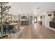Open-concept living area featuring a dining table and chairs, kitchen with island, and wood-look floors at 602 Cr 489, Lake Panasoffkee, FL 33538