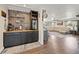 Open living space featuring a custom bar area with wood accents, wet bar, and refrigerator at 602 Cr 489, Lake Panasoffkee, FL 33538