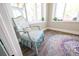 Bright office space featuring a patterned chair, colorful rug, and a large window at 602 Cr 489, Lake Panasoffkee, FL 33538