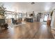 Spacious open-concept living area with hardwood floors, a kitchen island, and farmhouse decor at 602 Cr 489, Lake Panasoffkee, FL 33538