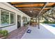 Relaxing covered patio with a TV, ceiling fans, and comfortable seating overlooking the pool and backyard at 602 Cr 489, Lake Panasoffkee, FL 33538