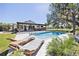 Enjoy the sun with this outdoor oasis featuring a large pool, sun loungers, and beautiful landscaping at 602 Cr 489, Lake Panasoffkee, FL 33538