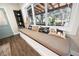 Charming window seat with decorative pillows, adjacent to a window offering backyard views at 602 Cr 489, Lake Panasoffkee, FL 33538