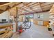 Spacious workshop with a variety of tools, equipment, and natural light from the open bay door at 602 Cr 489, Lake Panasoffkee, FL 33538