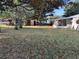 Expansive backyard featuring a small shed, boat on trailer, and partial view of the house with a screened porch at 608 Gray Ave, Wildwood, FL 34785