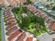 Aerial view showcases the community's layout with lush green spaces, a pool, and well-maintained residential areas at 632 Delgado Ave, The Villages, FL 32159