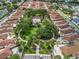 Community aerial view featuring the central community pool, green spaces, and surrounding residential homes at 632 Delgado Ave, The Villages, FL 32159
