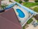 An aerial view shows the pool, patio, roof and painted fence in the backyard at 632 Delgado Ave, The Villages, FL 32159