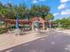 Relaxing community area showcasing covered seating, tables, and serene landscaping for leisure and gatherings at 632 Delgado Ave, The Villages, FL 32159