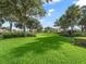 Lush community green space with mature trees, providing a serene and inviting atmosphere at 632 Delgado Ave, The Villages, FL 32159