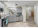 Modern kitchen featuring stainless steel appliances, gray cabinetry, and granite countertops at 632 Delgado Ave, The Villages, FL 32159