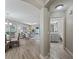 Open-concept design shows the living and dining room with luxury floors, natural light and an attached half-bath at 632 Delgado Ave, The Villages, FL 32159