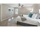 Bright main bedroom features luxury flooring, a ceiling fan and natural light from french doors at 632 Delgado Ave, The Villages, FL 32159